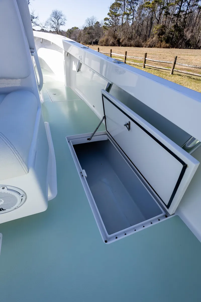 Slide: The Image of 2005 French Yachts 34 Center Console with open storage compartment on deck. - 36