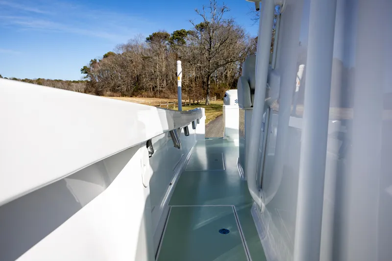 Slide: The Image of 2005 French Yachts 34 Center Console, side view, docked near wooded shoreline. - 38