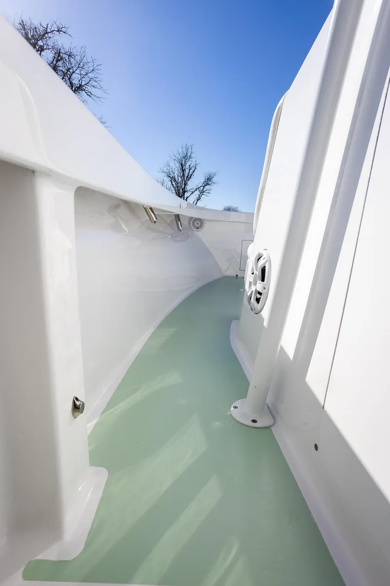 Slide: The Image of 2005 French Yachts 34 Center Console, sleek white deck, clear blue sky background. - 39