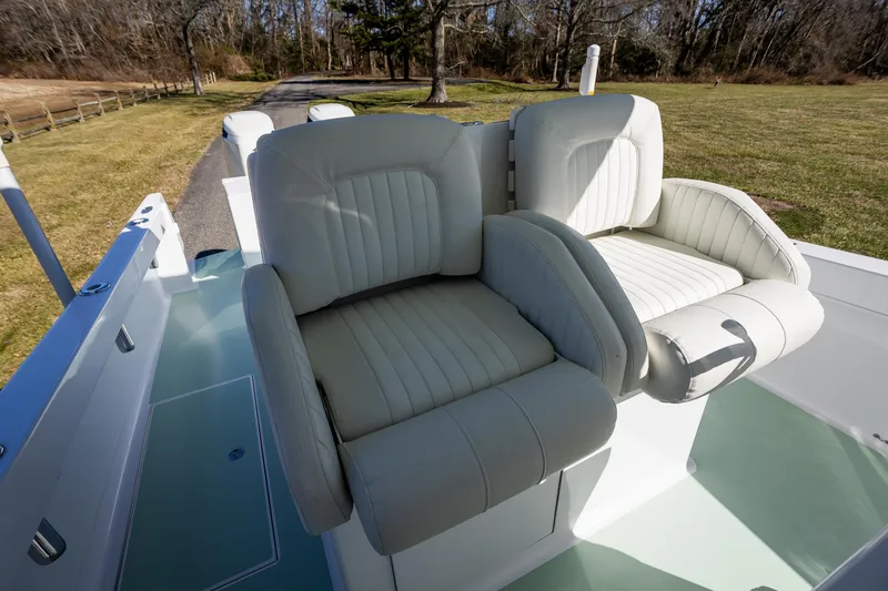 Slide: The Image of Luxurious seating on 2005 French Yachts 34 Center Console boat, featuring plush white upholstery. - 42