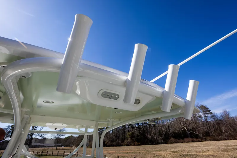 Slide: The Image of 2005 French Yachts 34 Center Console, rod holders, clear sky background. - 43