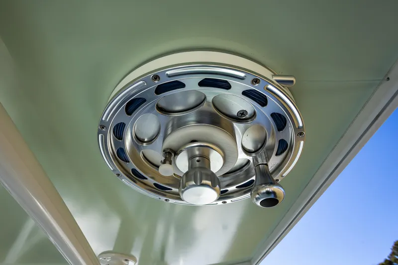 Slide: The Image of Close-up of a 2005 French Yachts 34 Center Console boat's metal reel mechanism. - 46