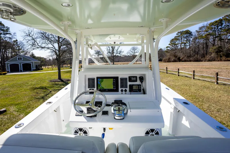 Slide: The Image of 2005 French Yachts 34 Center Console interior with navigation equipment and steering wheel. - 5