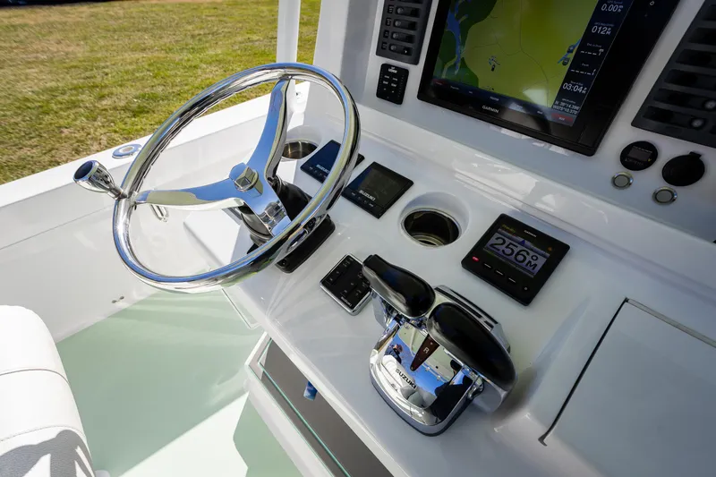 Slide: The Image of 2005 French Yachts 34 Center Console helm with steering wheel and navigation displays. - 6