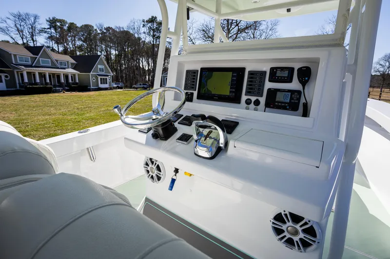 Slide: The Image of 2005 French Yachts 34 Center Console boat dashboard with navigation equipment and steering wheel. - 7