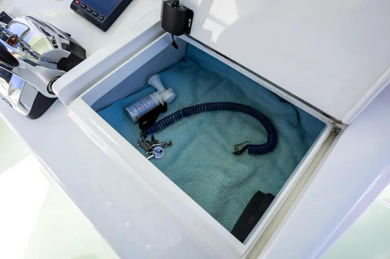 Slide: The Image of Storage compartment on a 2005 French Yachts 34 Center Console boat with coiled cable. - 9