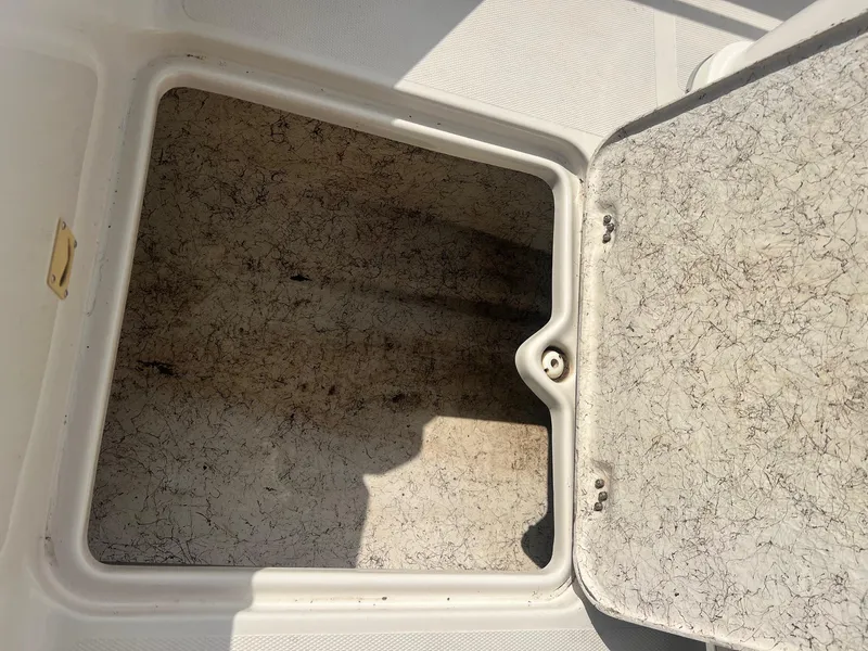 Slide: The Image of Open storage compartment on a 2001 Fishmaster 19 CC boat. - 11
