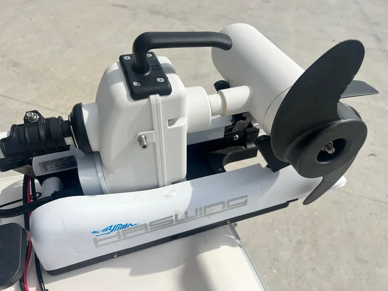 Slide: The Image of Electric boat motor on a 2001 Fishmaster 19 CC, featuring a sleek white design. - 13