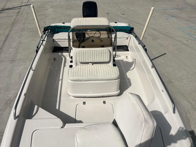 Slide: The Image of 2001 Fishmaster 19 CC boat interior with white seating and steering console. - 14