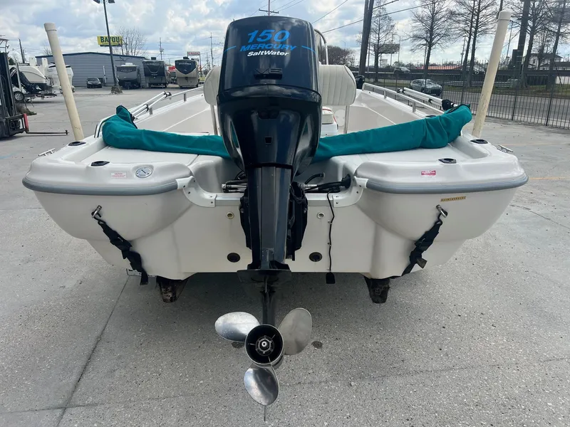 Slide: The Image of 2001 Fishmaster 19 CC boat with Mercury 150 outboard motor, parked outdoors. - 7