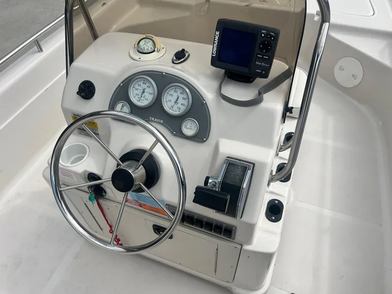 Slide: The Image of 2001 Fishmaster 19 CC boat console with steering wheel, gauges, and navigation equipment. - 9
