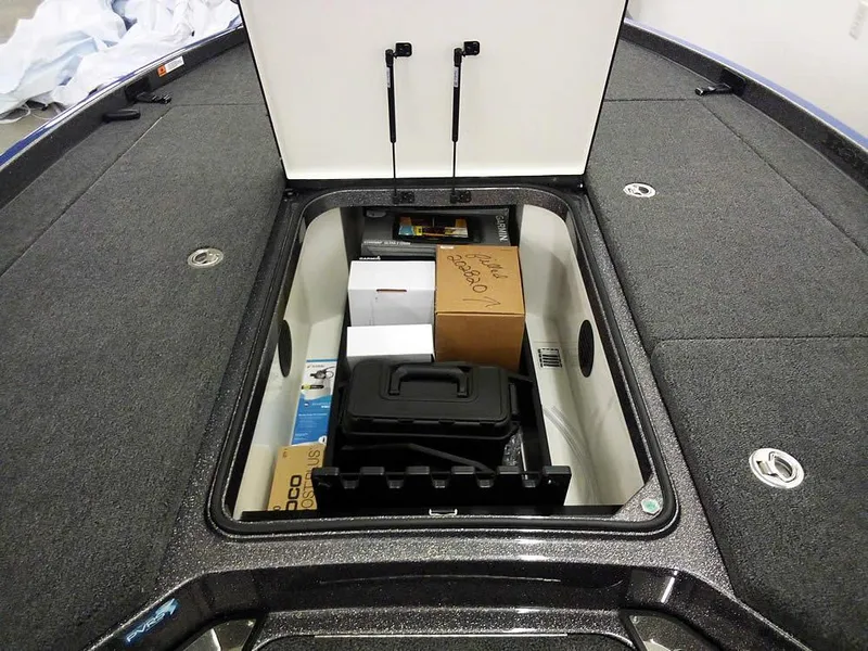 Slide: The Image of 2025 Ranger Z521R Garmin Ranger Cup Equipped boat storage compartment with various boxes and equipment. - 13