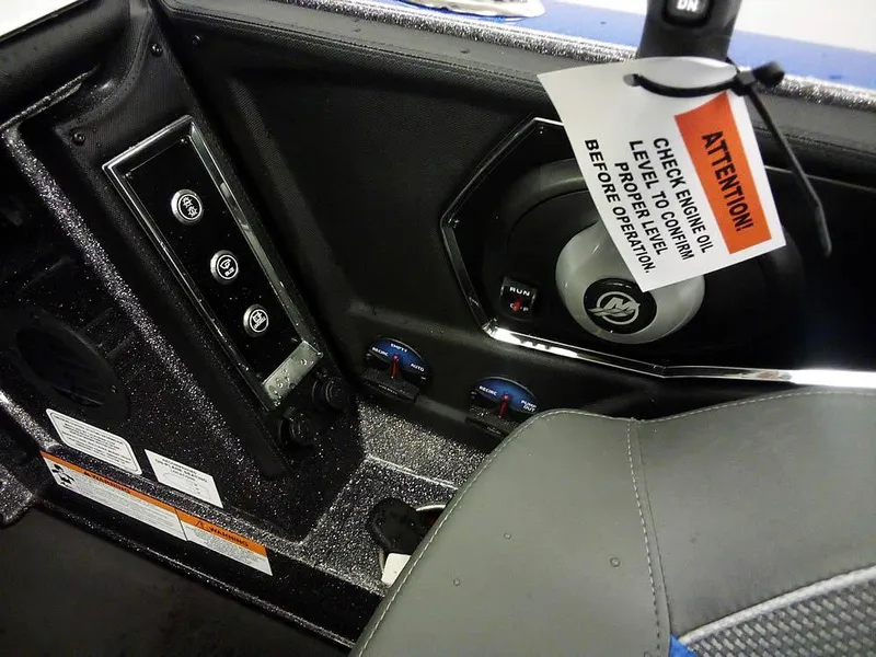Slide: The Image of 2025 Ranger Z521R Garmin Ranger Cup boat interior with control panel and warning tag. - 29