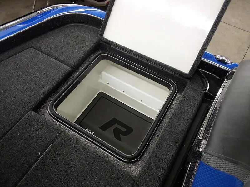 Slide: The Image of 2025 Ranger Z521R Garmin Ranger Cup Equipped storage compartment, open lid, black interior. - 33