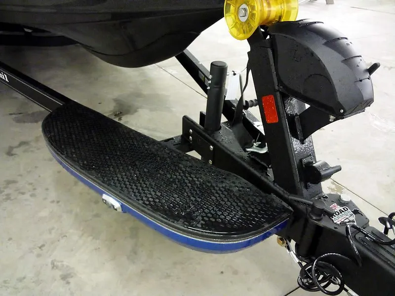 Slide: The Image of 2025 Ranger Z521R Garmin Ranger Cup trailer hitch and step detail in a garage. - 4