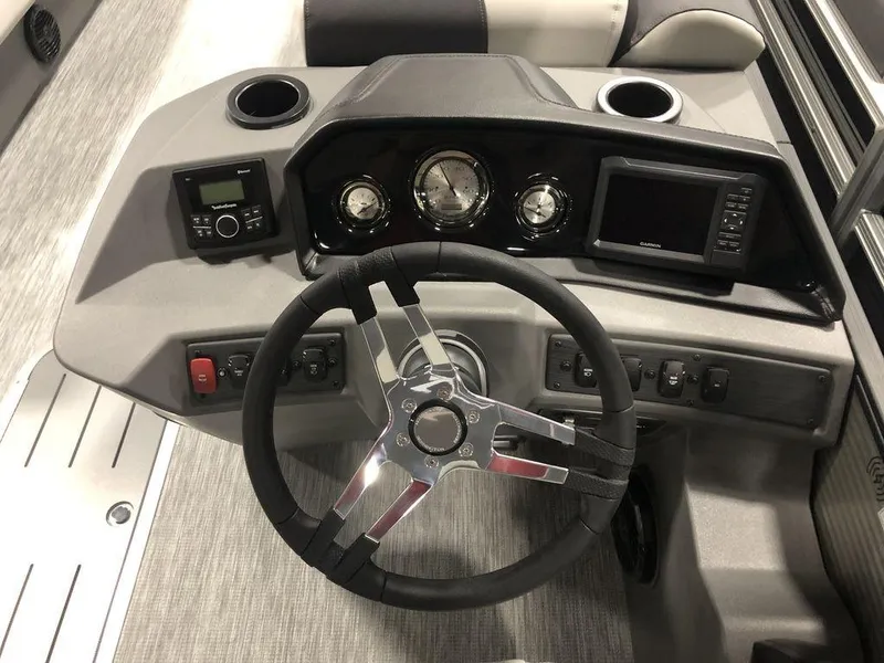 Slide: The Image of 2025 Bennington S Quad Bench 22 SSR boat dashboard with steering wheel and control panel. - 4