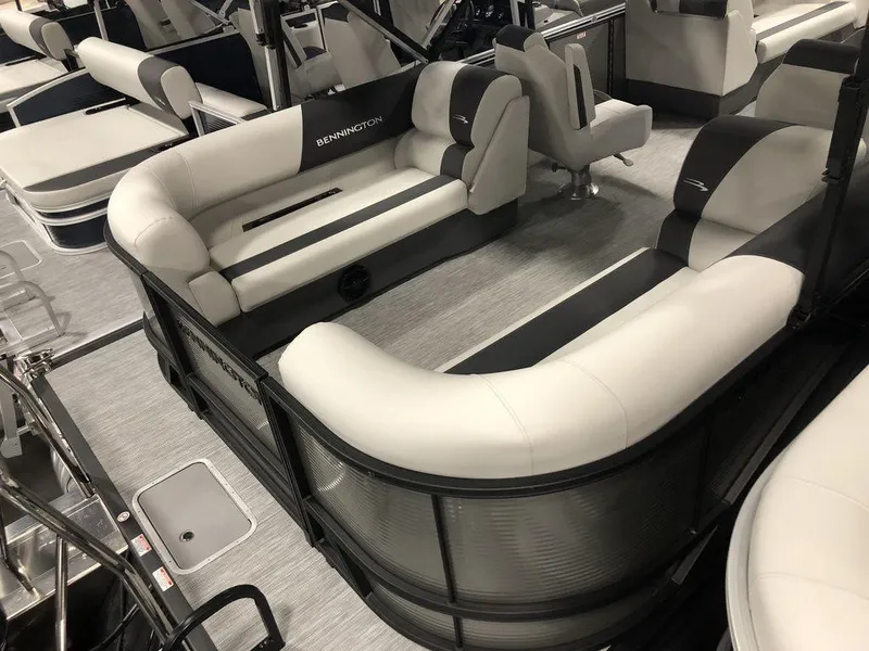 Slide: The Image of 2025 Bennington S Quad Bench 22 SSR pontoon boat interior with plush seating. - 5