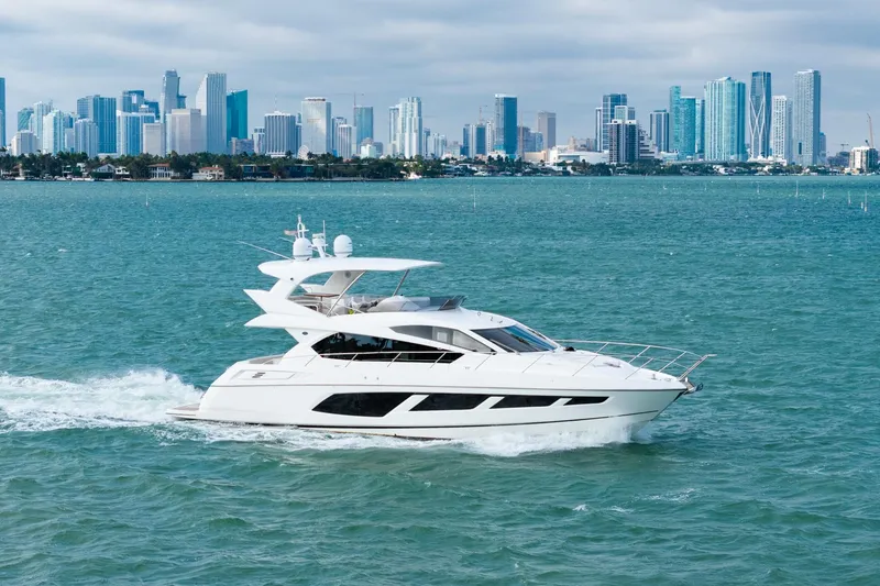 Slide: The Image of 2016 Sunseeker Manhattan 65 yacht cruising with city skyline backdrop. - 10
