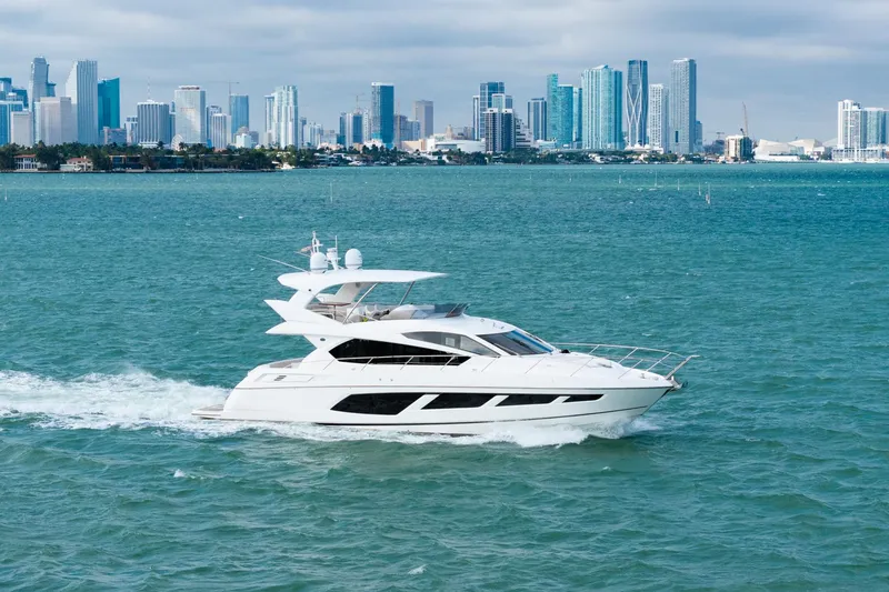 Slide: The Image of 2016 Sunseeker Manhattan 65 yacht cruising near a city skyline. - 11