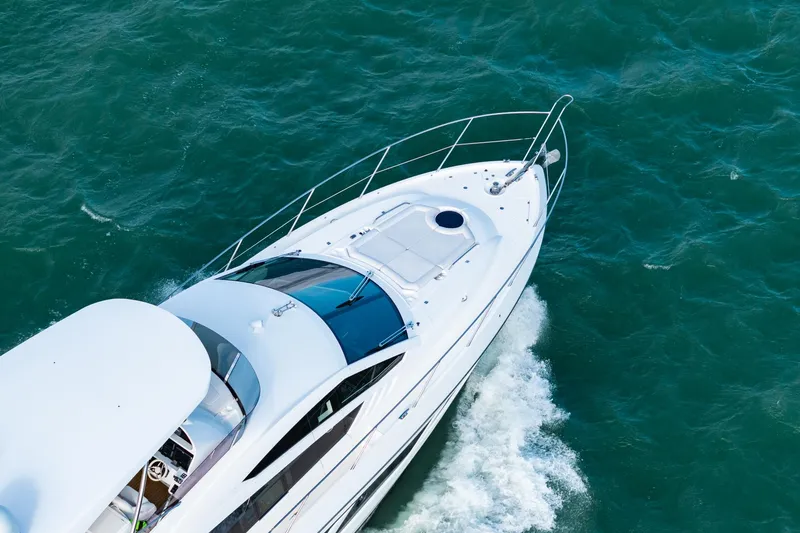 Slide: The Image of 2016 Sunseeker Manhattan 65 yacht cruising on open water. - 18