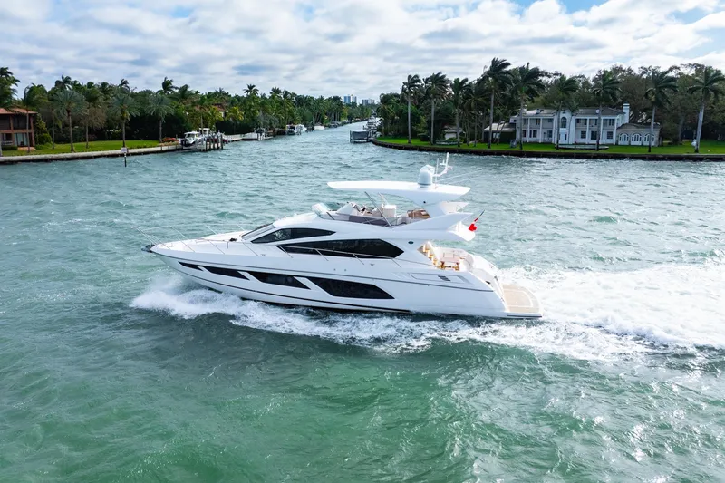 Slide: The Image of Sunseeker Manhattan 65 yacht cruising on a scenic waterway, 2016 model. - 2