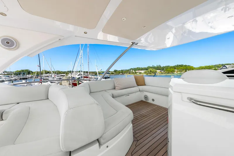 Slide: The Image of Luxurious 2016 Sunseeker Manhattan 65 yacht interior with white seating and wooden deck. - 36