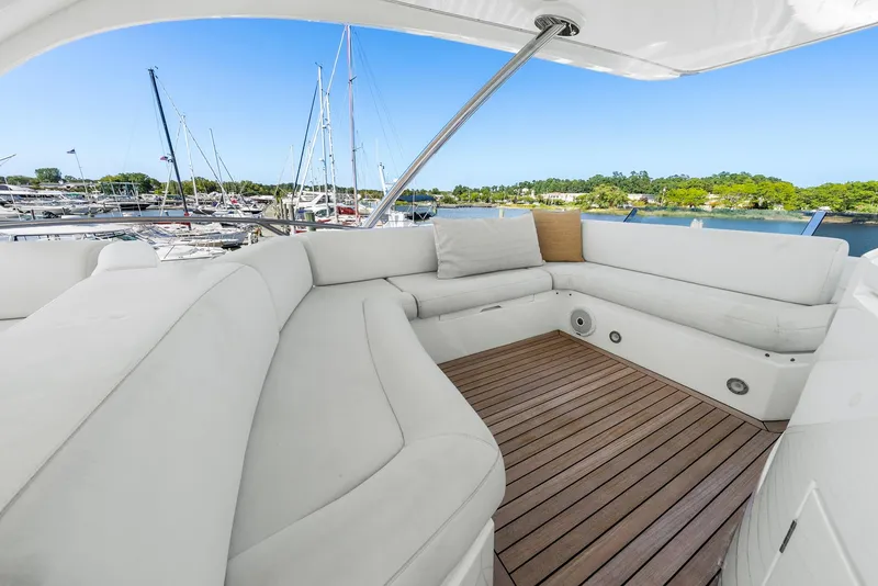 Slide: The Image of Luxurious seating area on 2016 Sunseeker Manhattan 65 yacht, docked at marina. - 37