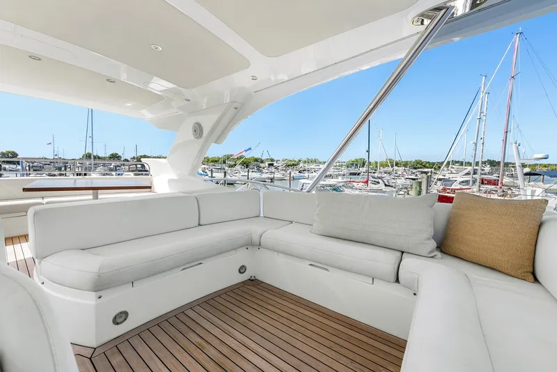 Slide: The Image of Luxurious Sunseeker Manhattan 65 yacht interior, 2016 model, featuring elegant white seating and marina view. - 38