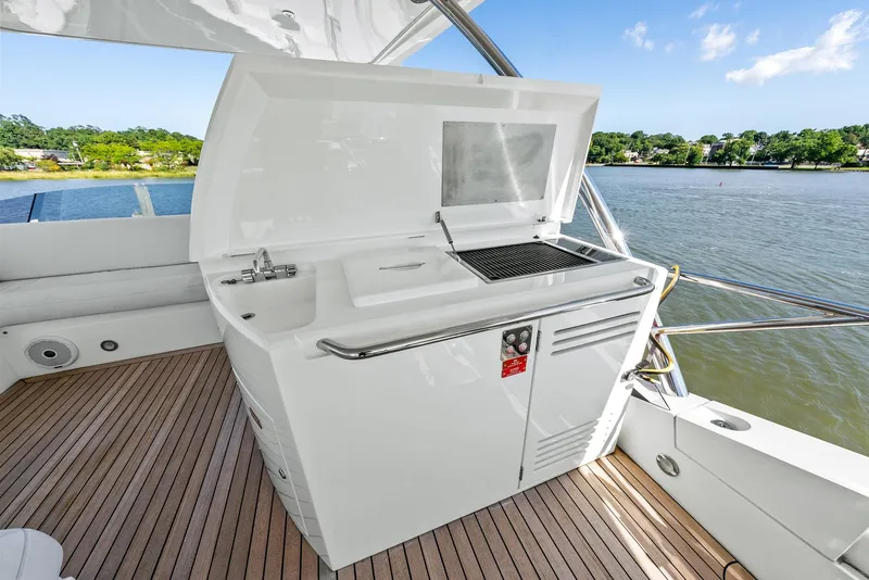 Slide: The Image of Outdoor kitchen on 2016 Sunseeker Manhattan 65 yacht, featuring grill and sink by the water. - 43