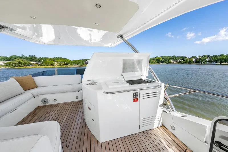 Slide: The Image of Luxurious 2016 Sunseeker Manhattan 65 yacht deck with seating and water view. - 44