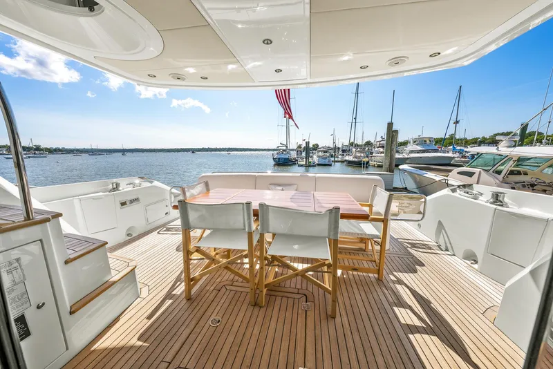 Slide: The Image of Sunseeker Manhattan 65 yacht deck with seating, overlooking marina, 2016 model. - 46