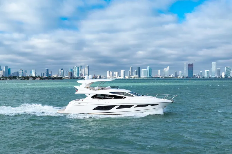 Slide: The Image of 2016 Sunseeker Manhattan 65 yacht cruising near city skyline. - 8