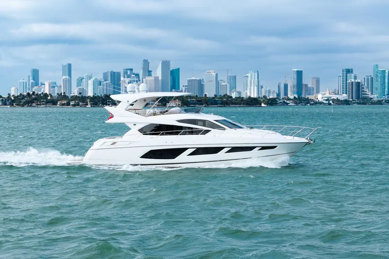 Slide: The Image of 2016 Sunseeker Manhattan 65 yacht cruising with city skyline backdrop. - 9