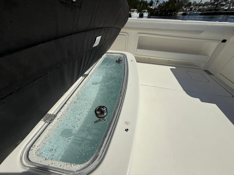 Slide: The Image of 2025 World Cat 325 CC boat deck with open storage compartment. - 10