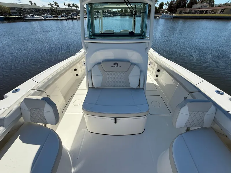 Slide: The Image of 2025 World Cat 325 CC boat interior with cushioned seating and waterfront view. - 17