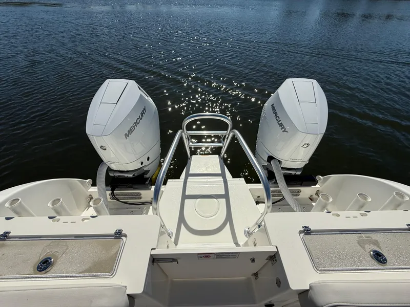 Slide: The Image of 2025 World Cat 325 CC boat with dual Mercury engines on calm water. - 7