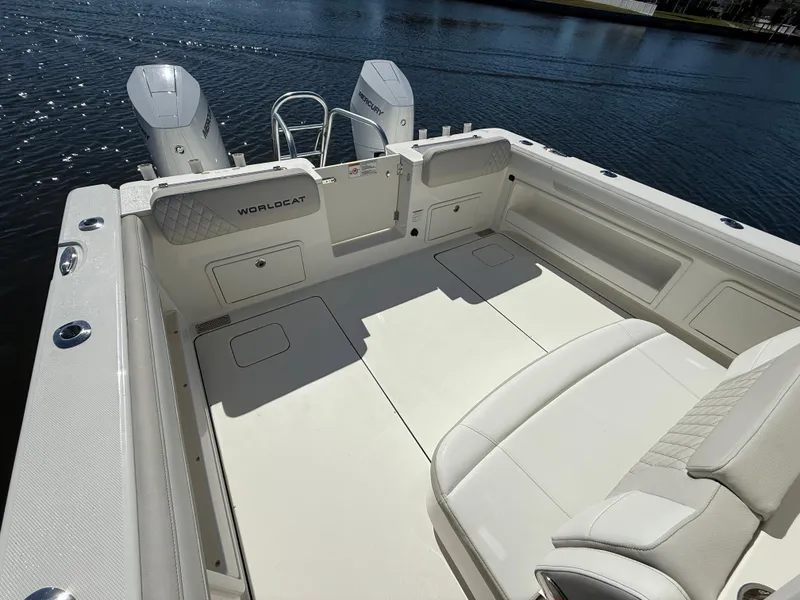 Slide: The Image of 2025 World Cat 325 CC boat interior with dual engines on a sunny day. - 8