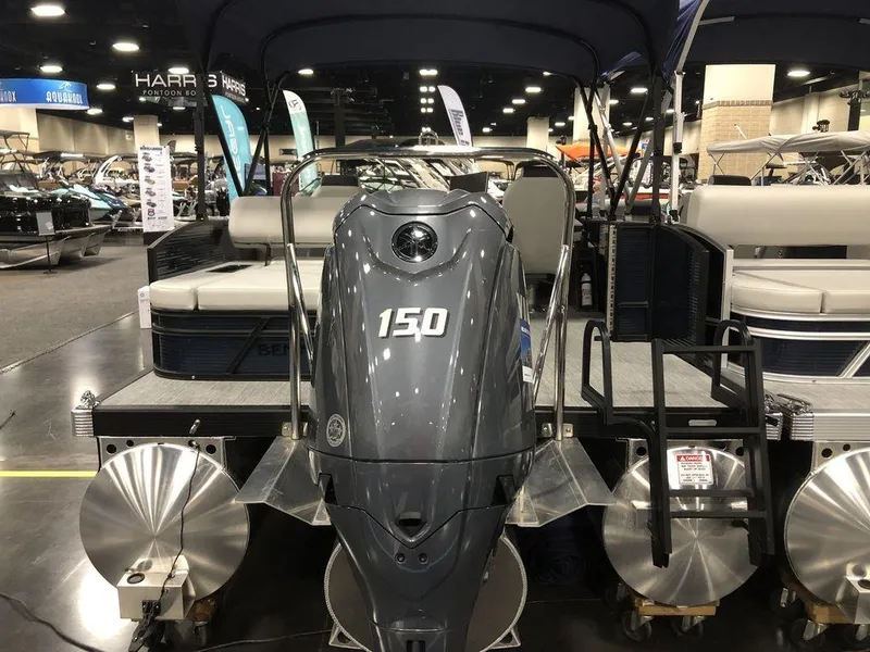 Slide: The Image of 2025 Bennington S Swingback 22 SSB pontoon boat with 150 HP engine at a boat show. - 8