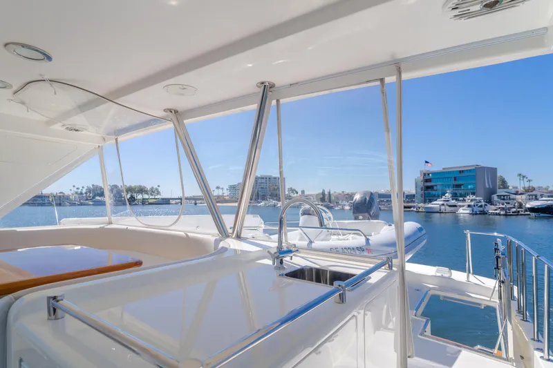 Slide: The Image of 2008 Ocean Alexander Pilothouse yacht with marina view, featuring sleek design and spacious deck. - 13