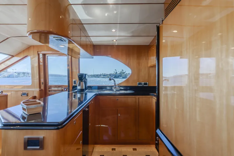 Slide: The Image of Luxurious 2008 Ocean Alexander Pilothouse yacht kitchen with sleek wood cabinetry and ocean view. - 28