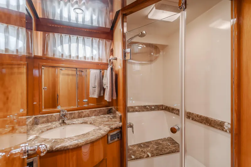 Slide: The Image of Luxurious bathroom in 2008 Ocean Alexander Pilothouse yacht with marble countertop and glass shower. - 35