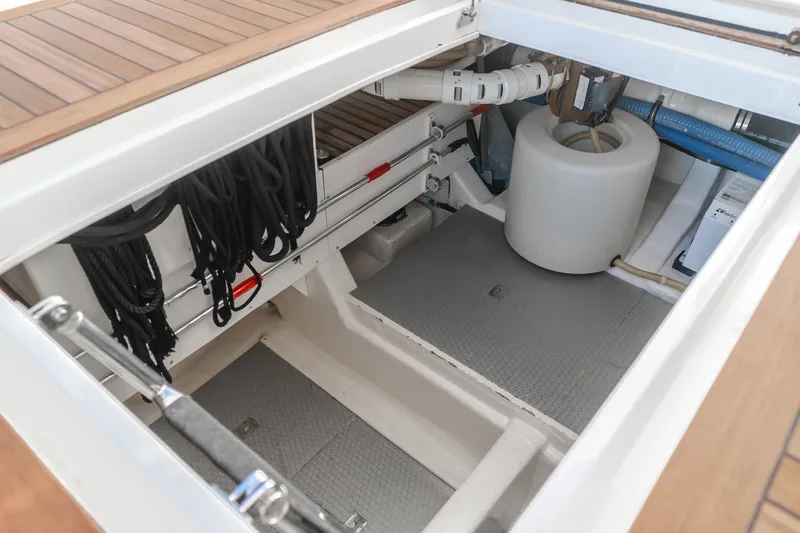 Slide: The Image of 2008 Ocean Alexander Pilothouse storage compartment with ropes and equipment. - 44