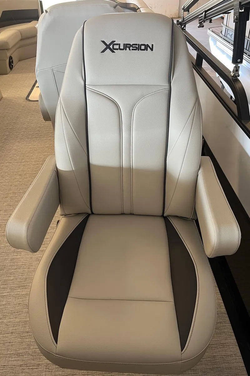 Slide: The Image of 2023 Xcursion 243 PFX boat seat, beige and black design, comfortable armrests. - 12