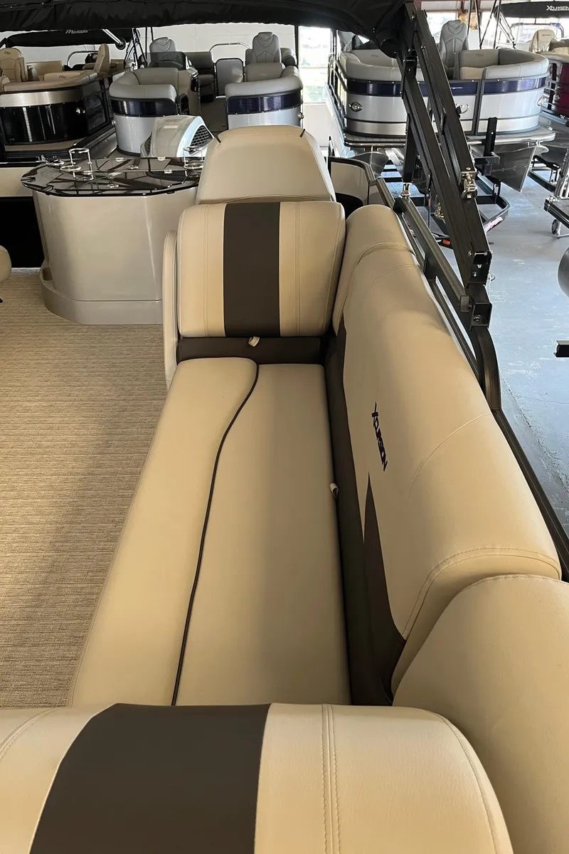 Slide: The Image of 2023 Xcursion 243 PFX pontoon boat interior with beige and brown seating. - 16