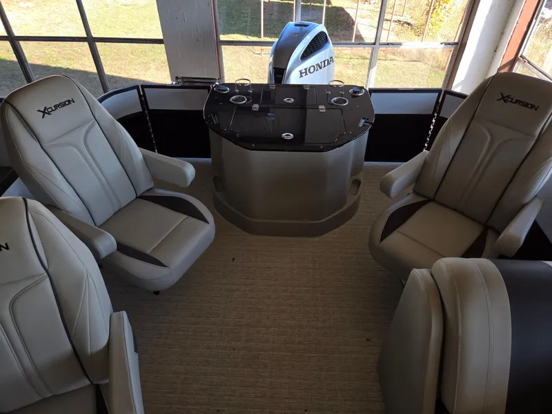 Slide: The Image of 2023 Xcursion 243 PFX boat interior with four seats and Honda engine. - 3