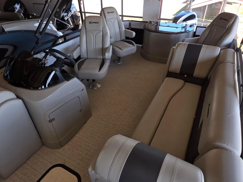 Slide: The Image of 2023 Xcursion 243 PFX boat interior with plush seating and modern design. - 4