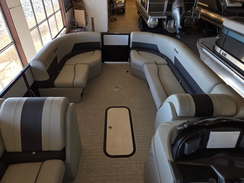 Slide: The Image of 2023 Xcursion 243 PFX pontoon boat interior with spacious seating and modern design. - 5
