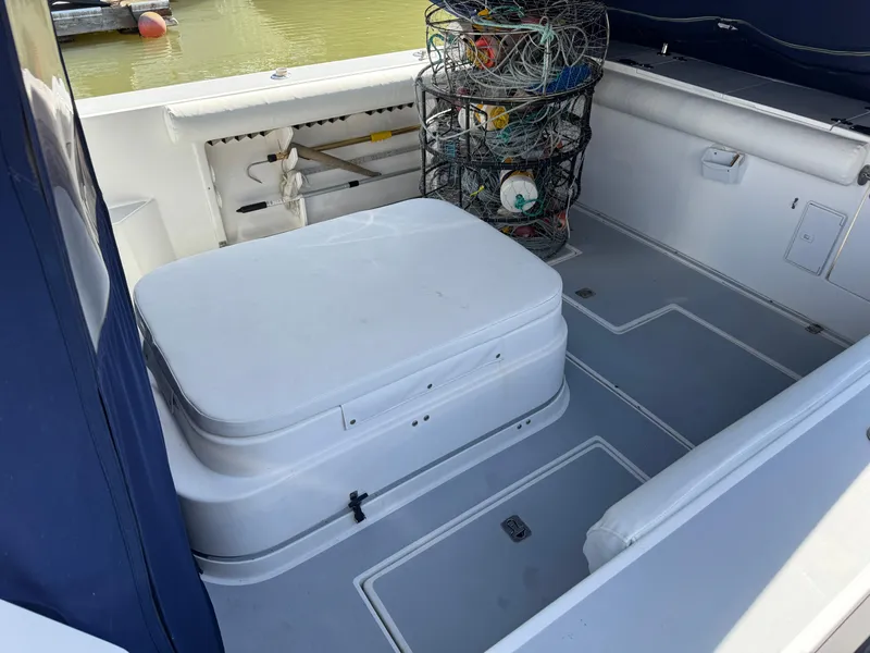 Slide: The Image of 2005 Albin 28 Tournament Express boat interior with seating and fishing gear. - 14