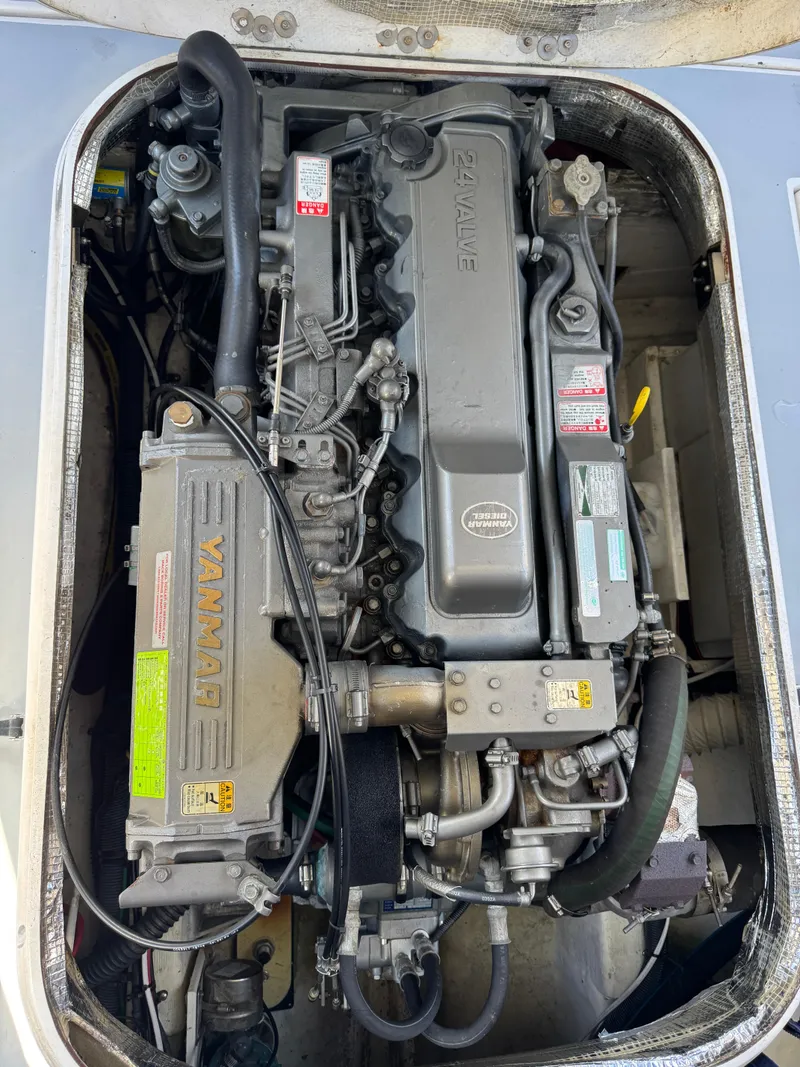 Slide: The Image of Engine of a 2005 Albin 28 Tournament Express boat, showcasing detailed mechanical components. - 16
