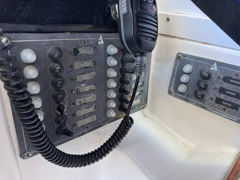 Slide: The Image of Control panel of a 2005 Albin 28 Tournament Express boat with radio handset. - 17